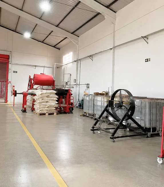 Fábrica da Biocarmim com maquinário industrial, sacas de matéria-prima e tanques usados na produção de corante natural vermelho